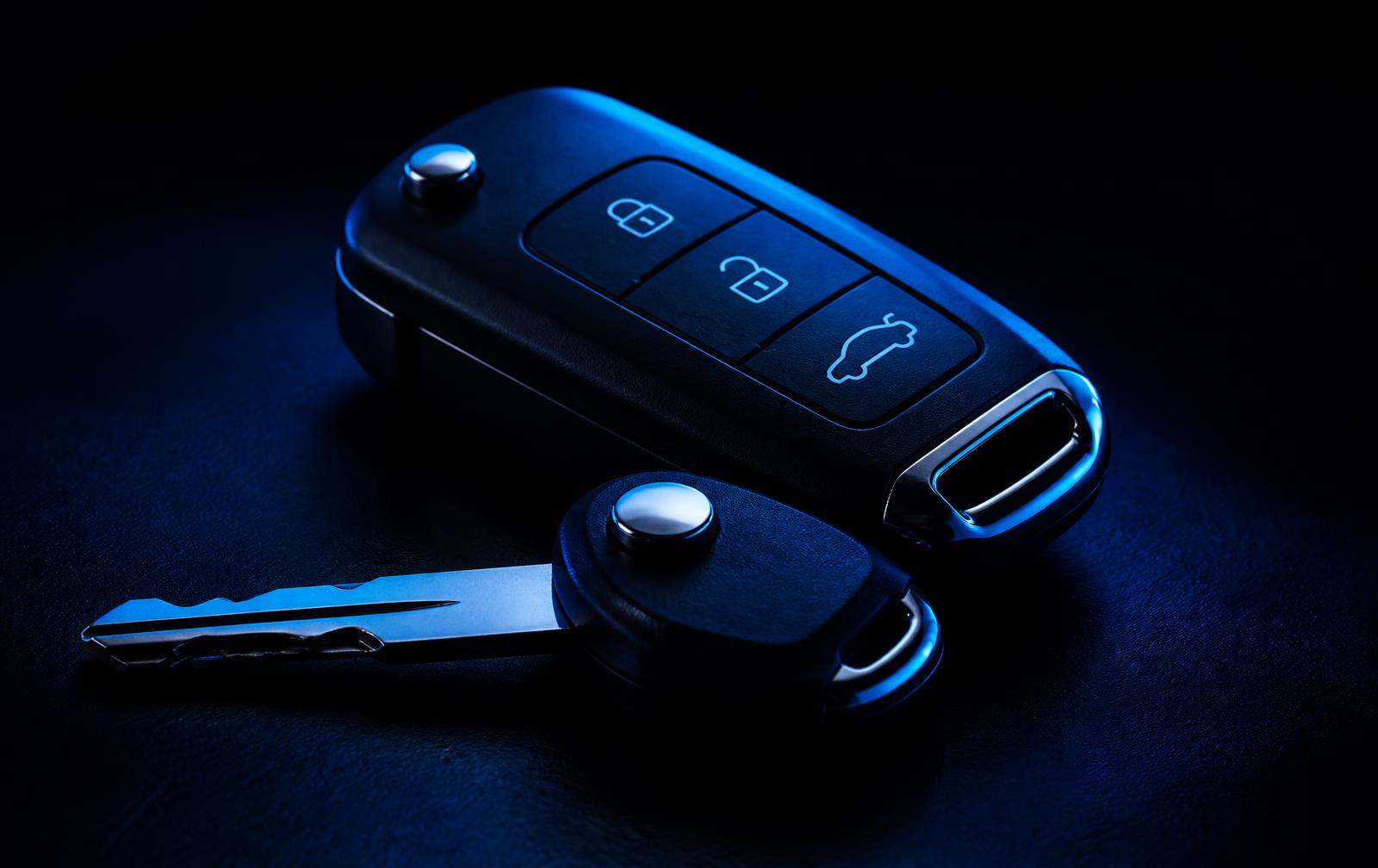 Car key fob and cut car key lit in electric blue, ready for programming
